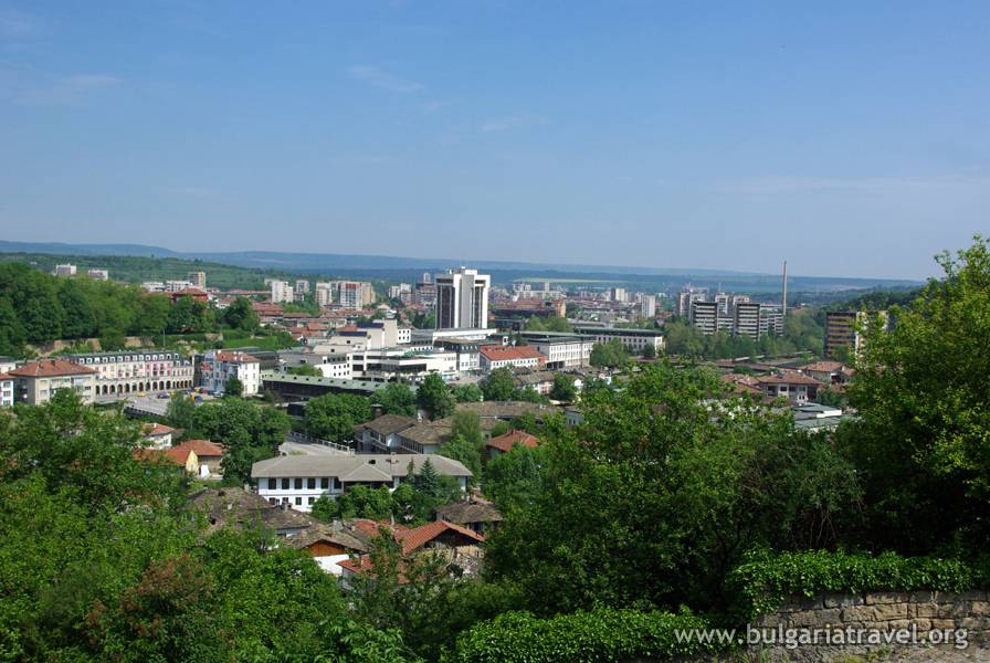 A panoramic cityscape seen from a hilltop, showcasing the urban landscape and its surrounding areas.