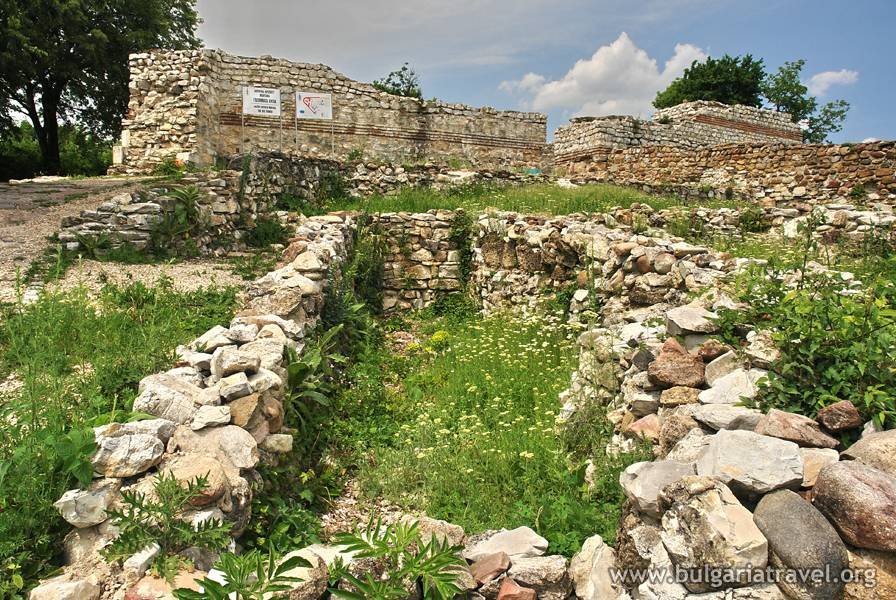 The weathered stone wall of the ancient castle stands tall, showcasing its rich history and grandeur.