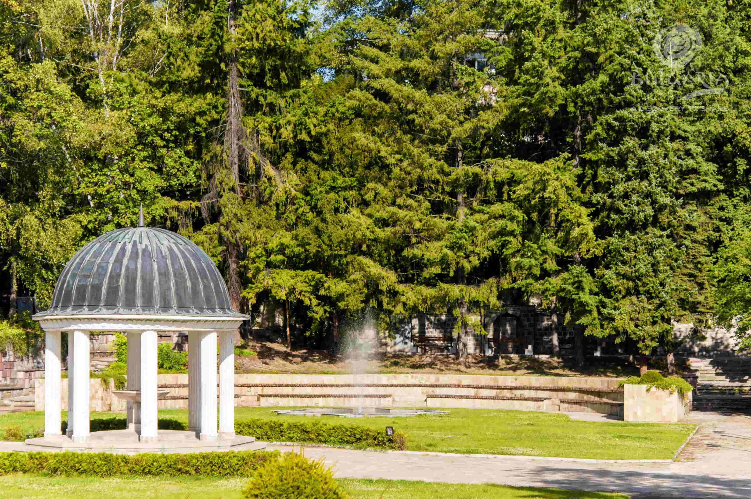 A serene white gazebo nestled in a picturesque park, offering a tranquil spot for relaxation and gatherings.